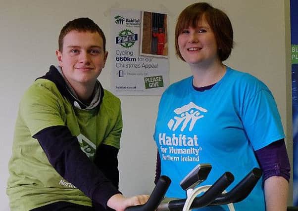 Adam (16) starts his cycle, pictured here with Habitat ReStore manager Isobel