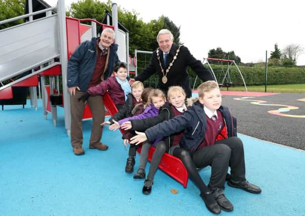The Mayor of Lisburn & Castlereagh City Council, Councillor Brian Bloomfield MBE and the Chairman of the Councils Chairman of Leisure & Community Development Committee, Councillor Tim Morrow with children from Largymore Primary School trying out the newly revamped Barbour Play Park.