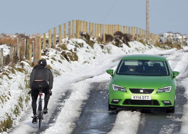 Cycling  through the snowy conditions on Divis Mountain 
Photo Colm Lenaghan/Pacemaker Press