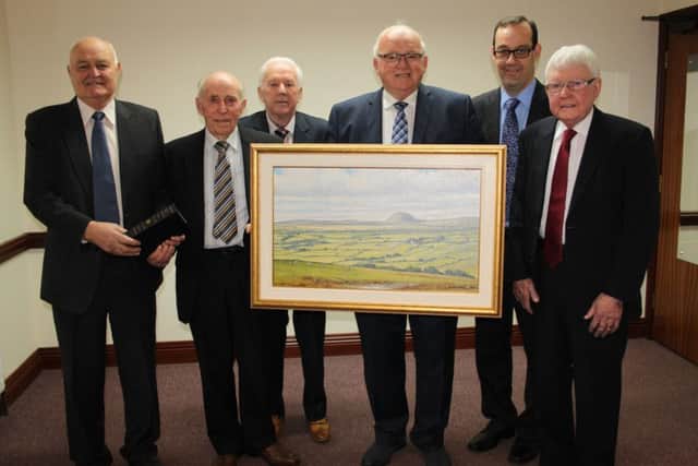 Senior elders of Glenwherry Presbyterian Church make a presentations to Huston Hoey to mark his retirement from the position of Clerk of Session.