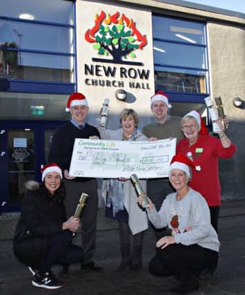 Cheque by the ASDA Foundation for Ashes to Gold and pictured are Roy Warke Coleraine General Store Manager, Mayor Ald Maura Hickey of Causeway Coast and Glens Council, Alastair Christie from 2nd Chance, Coleraine ASDA Community Champion Sheila Palmer, Cllr Stephanie Quigley and Mandy Forgrave at the ASDA community Christmas party held at New Row Presbyterian Church Hall. ASDA New Row 04