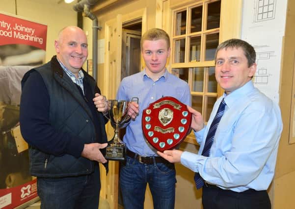 SERC carpentry and joinery apprentice William Campbell from Donaghcloney won a gold medal at the WorldSkills Competition in Birmingham. William is pictured with mentor Rodney McKee from Kilkeel (right)  and his employer Stephen Hamilton proprietor of Stephen Hamilton Construction (left).