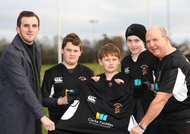 Mark Wiggins of Clarke Facades presents Gary Donald and Ballymena Bear players with their new rugby shirt. (submitted picture).