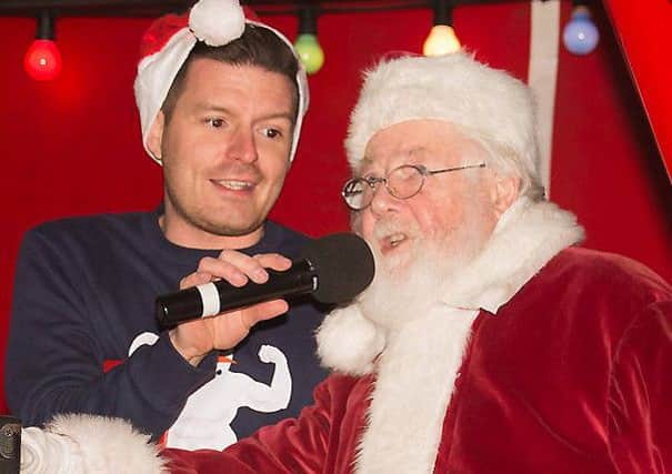 Simon Henry (Church of Ireland Youth Officer) pictured welcoming Santa.  (Photo by Joy Wells).