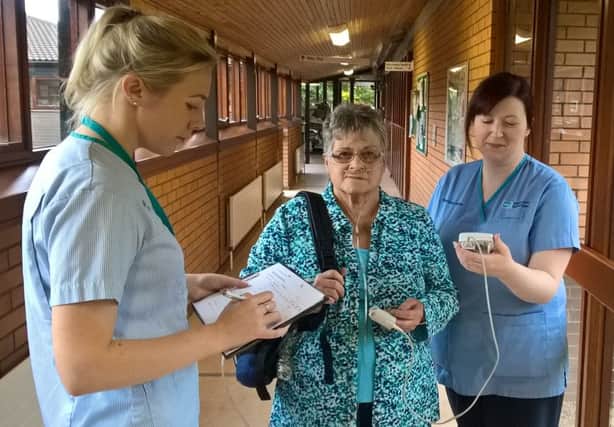 Lorraine Robinson taking part in a timed walking test as part of her care from the Northern Trusts Home Oxygen Service, Assessment and Review (HOS-AR), pictured with Tanya Burnside, Respiratory Nurse and Katherine Smyth, Respiratory Support Assistant