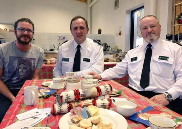 Chief Inspector Roy Robinson and Inspector Keith Jamieson support Breakthru at the charitys Christmas coffee morning. Pictured with Robin Walker