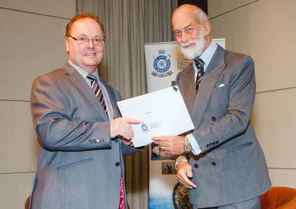 Jim McCurry (left) receives the 125th Anniversary Certificate of Merit from HRH Prince Michael of Kent, Commonwealth President of the Royal Life Saving Society.