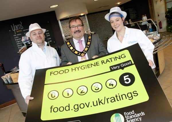 Mayor of Antrim and Newtownabbey, Cllr John Scott is joined by Colin Kelly, Environmental Health Manager and Kerry Gribbin, Environmental Health Officer to promote the new food hygiene rating legislation. INNT 50-809CON