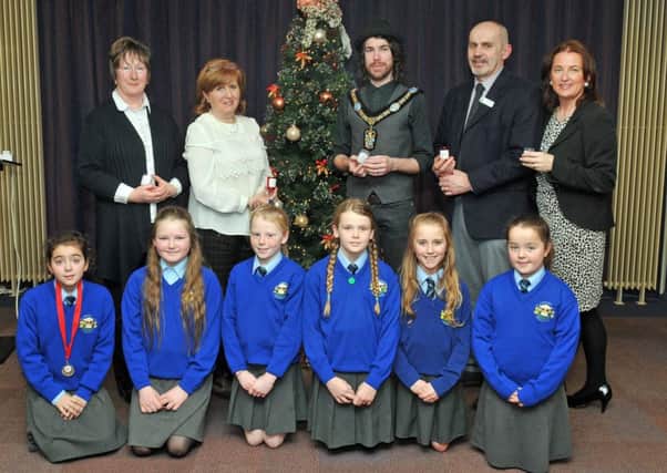 Lord Mayor of Armagh City, Banbridge and Craigavon, Councillor Garath Keating at the Southern Area Hospice Services, Light Up A Life Ceremony in Craigavon Civic Centre with, Ann Dalzell and Deirdre Breen, Hospice Friends Support Group, Rev Graham Stockdale, Hospice Chaplain, Siobhan McArdle, Hospice Fundraising and members of the St Anthonys Primary School choir.