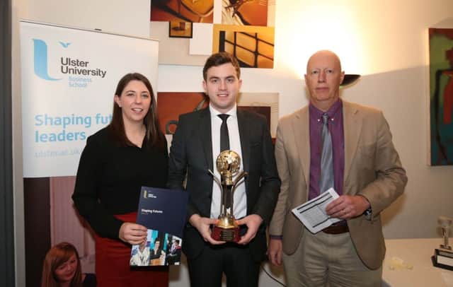 Ronan McGuckin (centre) is presented with the First Trust Bank award by Karen ONeill watched by Mike Pogue, Ulster University Business School.