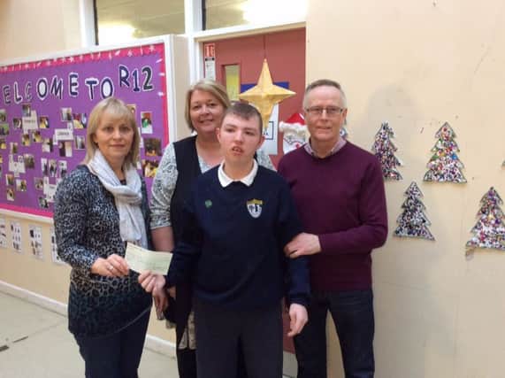 Margaret and Seamus Mullan presenting the cheque to Rossmar School, pictured with Michael Cartin.