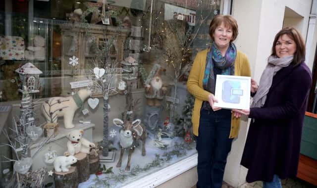 Ruth Davidson, owner of Mulberry Cottage, accepts her prize for winning Coleraine Town Teams Best Dressed Window competition from Causeway Coast and Glens Borough Council Officer Julienne Elliott.