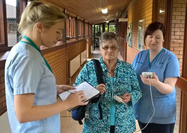 Lorraine Robinson taking part in a timed walking test as part of her care from the Northern Trusts Home Oxygen Service, Assessment and Review (HOS-AR), pictured with Tanya Burnside, Respiratory Nurse and Katherine Smyth, Respiratory Support Assistant. (Submitted Pic.)