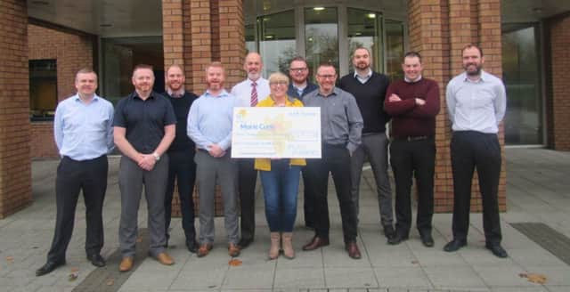 Mid Ulster District Council Planning staff who took part in a NovemBEARD fundraising campaign present Â£3,197.25 to Marie Curie Cancer Care.