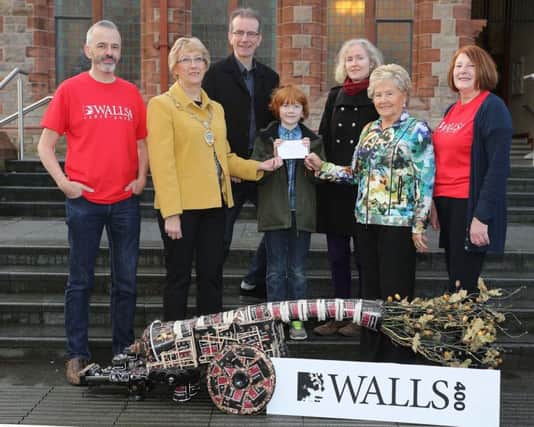 Ald. Hilary McClintock, Mayor, and Cecilia McCole, Sandwich Co, presenting the First Prize in the Derry Walls Day Treasure Hunt to Patrick Rooney. Watching are his parents, Hilary and Jimmy Rooney, and Niall McCaughan and Anne McCartney, Friends of the Derry Walls. Photocredit: Lorcan Doherty Photography.