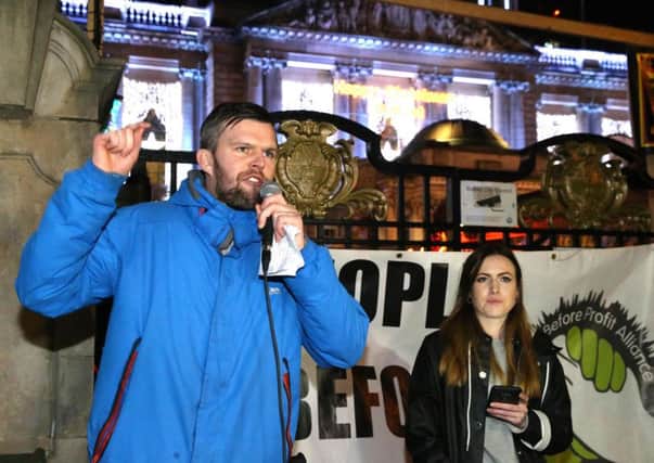 Firebrand: Gerry Carroll MLA addresses the crowds outside City Hall on Friday evening to demand the resignation of First Minister Arlene Foster over the Renewable Heat Incentive (RHI) scheme . Pic Pacemaker Press