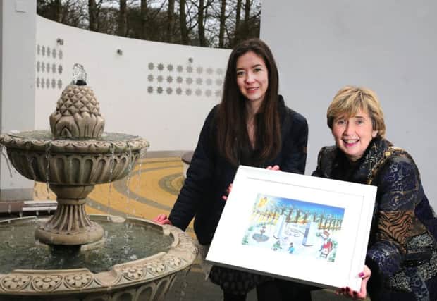 Artist Eloise Robertson pictured with the Mayor of Causeway Coast and Glens Borough Council, 
Alderman Maura Hickey, in the Garden of Hope in Coleraine with the artwork which inspired the 
Christmas card.PIC KEVIN MCAULEY/MCAULEY MULTIMEDIA