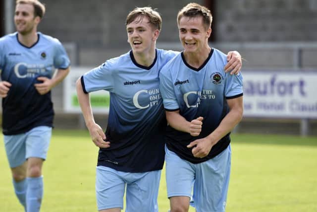 Institutes Gareth Brown (right) scored their first goal against Armagh City.