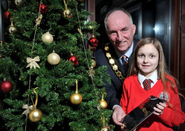 Molly Carson a pupil at Orritor Primary School who was the lucky winner of an Ipad Air in the Mid-Ulster District Counci Small Business Saturday competition held recently. Molly is pictured receiving her prize from Council Chairperson Trevor Wilson.INMM5116-317