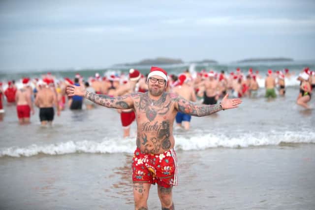 Jonathan Boyd in the water at the Santa Splash at the East Strand on Sunday. Picture Steven McAuley/PA