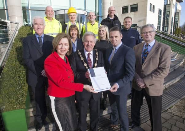 Pictured receiving the council's bronze Investors in People (IIP) accreditation from Eddie Salmon, IIP assessor, are: (front l-r) Dr Theresa Donaldson, Chief Executive; Mayor Brian Bloomfield MBE and Councillor Owen Gawith, Chairman of the council's Corporate Services Committee; (middle l-r) Adrian Donaldson, Director of Corporate Services; Diane Wilson; Caroline Magee; Lee Evans; (back l-r) John Leebody; Gary Wilson; David Henderson and Brian McIlroy.