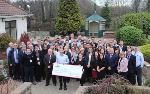 Aoibheann Doherty, Regional Fundraising Manager at Barnardo's Northern Ireland, is pictured being presented with theÂ donation from Tobermore's Managing Director, David Henderson, along with a number of Tobermore staff from across NI, ROI, England, Scotland and Wales.