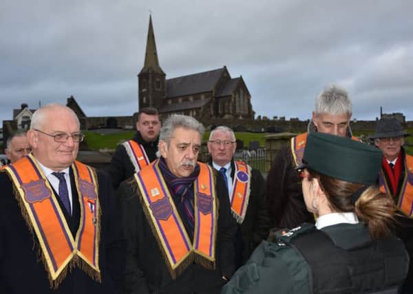 The Orangemen address a police officer during the protest