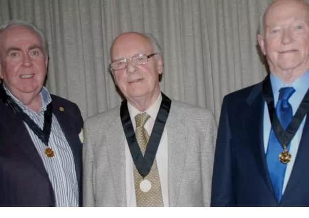 Ivan Davison, right, pictured receiving his 50-year medal for service to Portadown Male Vocie Choir. Also pictured are Gordon Speers (left) and Ivan Davision (right). INPT02-001