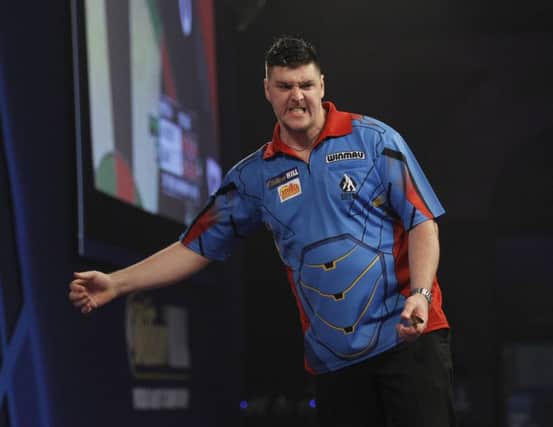 Daryl Gurney celebrates winning the third set against Mark Webster, at the William Hill World Darts Championship.