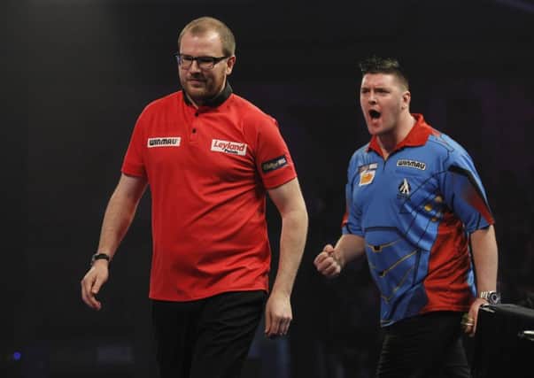 Daryl Gurney celebrates winning the third set against Mark Webster, at the William Hill World Darts Championship.