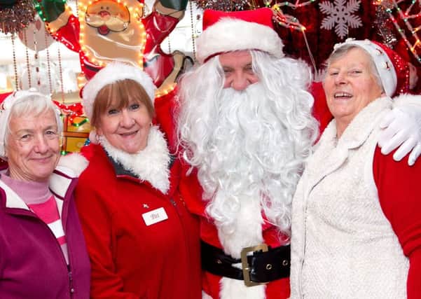 Santa made an appearance at the Drop In Charity Shop on Saturday to wish every one a Merry Christmas. Pictured with Staff Members Sandra Curran, Pat Butler and Joan Guiller   INCT 50-404-RM