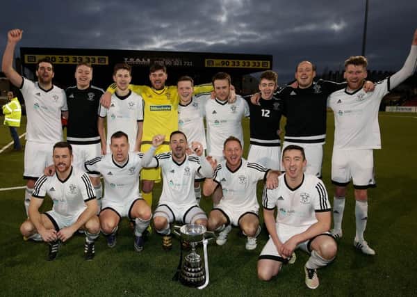 Rathfriland celebrate with the trophy they've waited so long to get their hands on.  Photographer - Matt Mackey / Press Eye