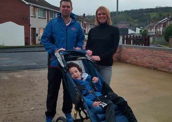 Dean Hogg and Karen Spiers are pictured with Finlay Spiers in his new 'running wheelchair'. INLT-02-704-con