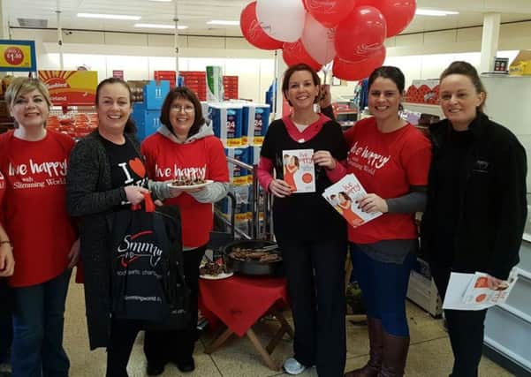 Members of the Newtownabbey Slimming World group distributed healthy options to local shoppers in December. INNT 02-821CON