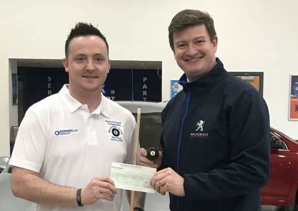 Richard Long (left) receiving a sponsorship cheque from Simon McMichael (Manager) Donnelly Group.