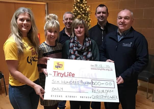 Andrea Milligan (left) from TinyLife receives a cheque for Â£600 from Joanne Casey (LaganView Centre Manager), Sharon Gibson (Resurgam Trust), Adrian Bird (Resurgam Trust Director), Alan Hurst (LaganView Enterprise Centre) and Gary Bolton (The Journey Church).