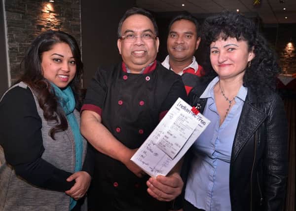 Hot Tip...The Indian Tree Restaurant staff pictured with the receipt for a tip of almost Â£1000 from a generous customer. Included are from left, Luna Ekush, director, Babu, chef, Martinho Silva, tandori chef, and Maria Bulcau, kitchen assistant. INPT02-206.
