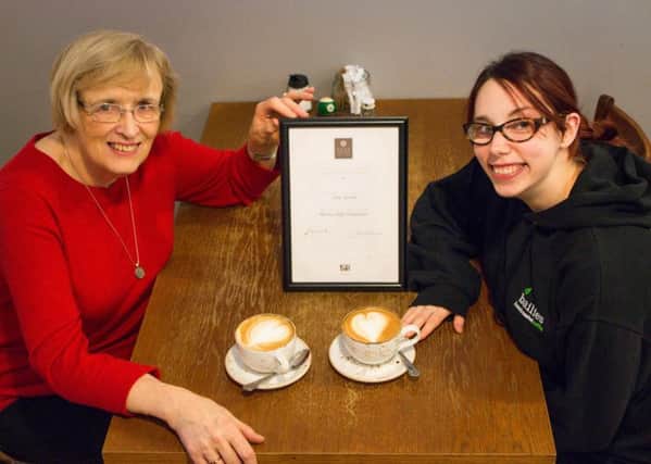 Irene Sproule receives her certificate from SCAE trainer Julia McKenna from Bailies Coffee Roasters.