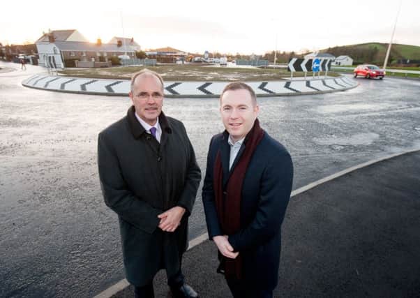 Infrastructure Minister Chris Hazzard (right) and Stephen Pollock from TransportNI Eastern Division check out the new roundabout at Temple Crossroads. Pic by Andrew Towe