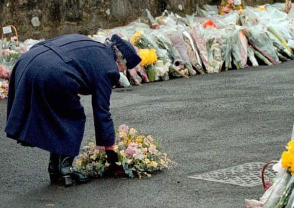 The Queen lays a wreath at Dunblane after the attack that killed 16 primary school pupils in 1996. Martyn James Price threatened a similar attack at an east Belfast school two years ago