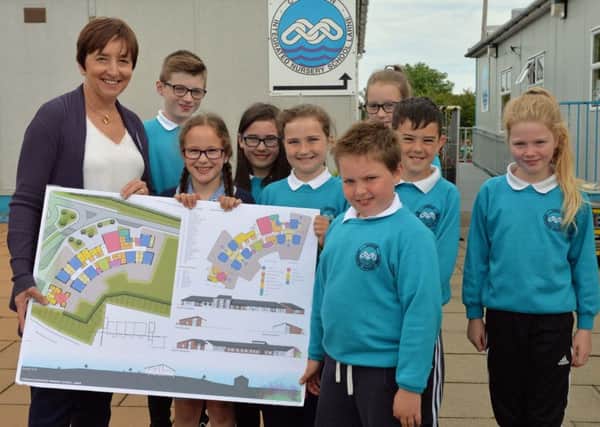 The principal of Corran Integrated Primary School, Mrs Denise Macfarlane and pupils from P4,5 & 6 with plans for their new school. INLT 26-001-PSB