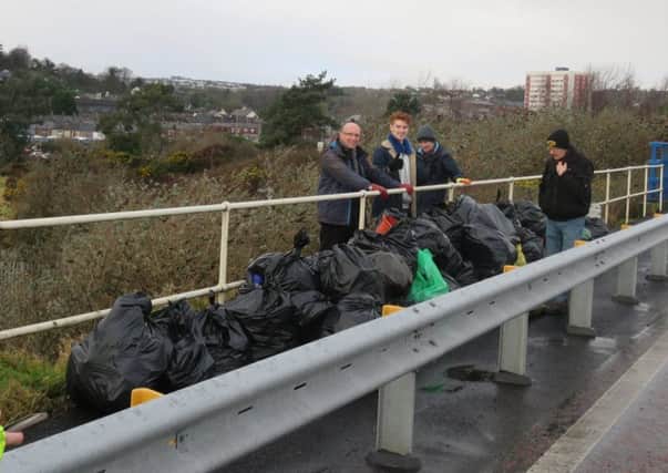Volunteers with some of the bags of rubbish collected from around Larne Lough. INLT-03-702-con