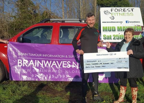 Lea Vaughan, owner of Forest Fitness presents a cheque to Kate Ferguson, Brainwaves NI. INCT 04-653-CON