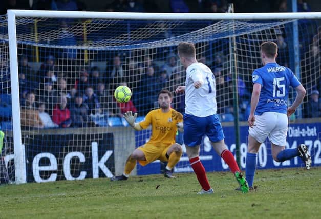 Linfield's Aaron Burns scores the opening goal past Glenavon goalkeeper Jonathan Tuffey during Saturday's  Danske Bank Premiership match at Mourneview Park. 
Picture by Brian Little/PressEye