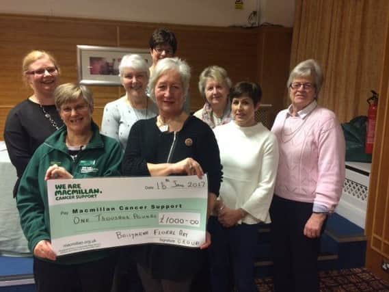 Ballymena Floral Art Group Chairman Ross McGookin presents a cheque for Â£1,000 to Cynthia Cherry in aid of Macmillan Cancer Support. Included are committee members, Colleen Hamill, Janet Wilson, Maureen Laverty, Adeline Cherry, Alana Forgrave and Avril Kidd. INBT 04-650-CON