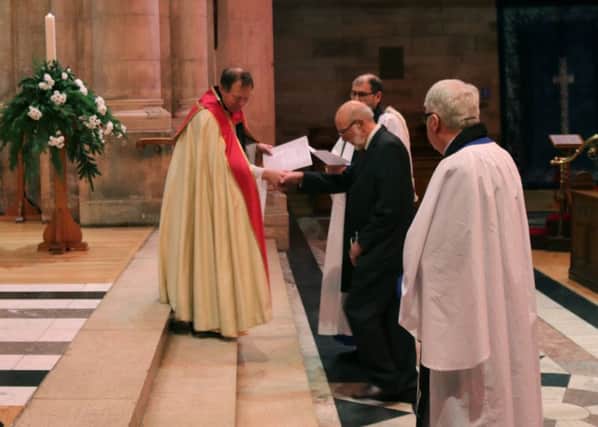 The Dean of Belfast leads new Lay Canon Robert Kay to his designated seat during the service of installation in St Annes Cathedral. INCR 04-702-CON