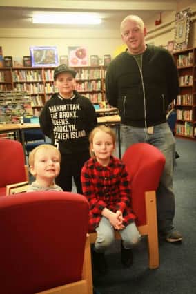 Wesley Doherty, and his children, Corey, Amy and Reilly, check out the library at Dunluce School