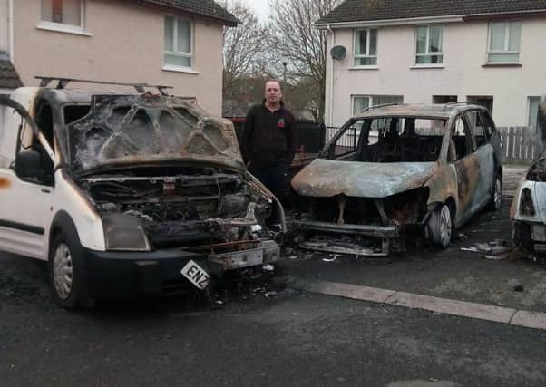 Stephen Crawford at vehicles which were attacked in Donaghcloney