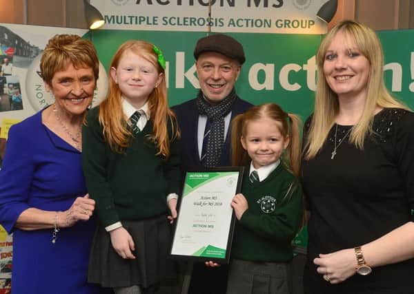 St Aloysius Primary School who raised Â£4,688.51. The photograph includes Mrs Ann Walker (Action MS Chief Executive) Mr john Daly (host and Action MS Patron) and Ms Ciara Bradley (teacher) with pupils (RHS) Caoimhe Duffy and Ava McGlynn
