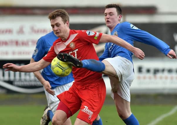 Portadown's Aaron Haire battling to shield the ball from Glenavon's James Singleton at Shamrock Park. Pic by PressEye Ltd.